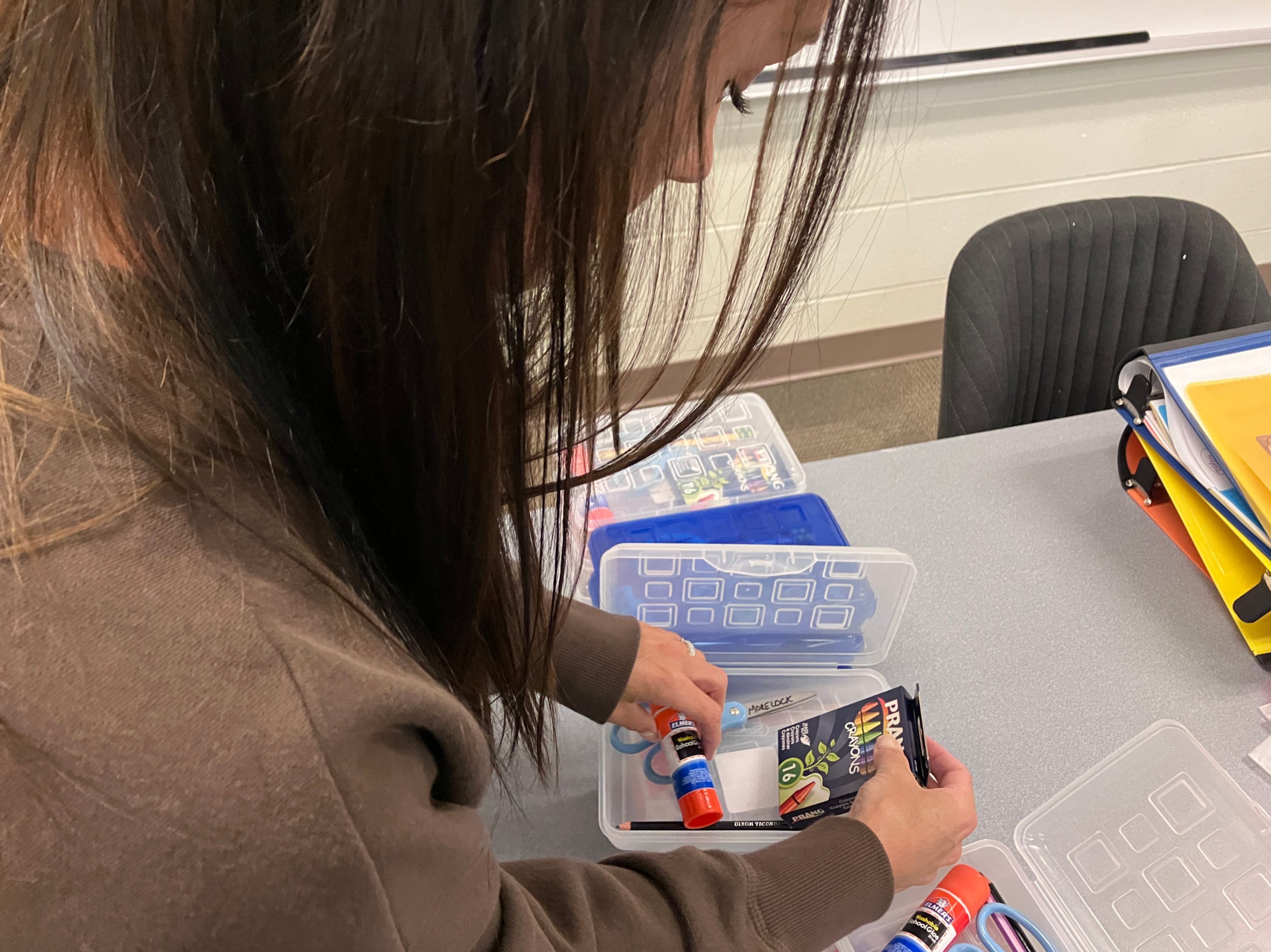 Mrs. Morelock organizes supplies in small containers in her classroom.
